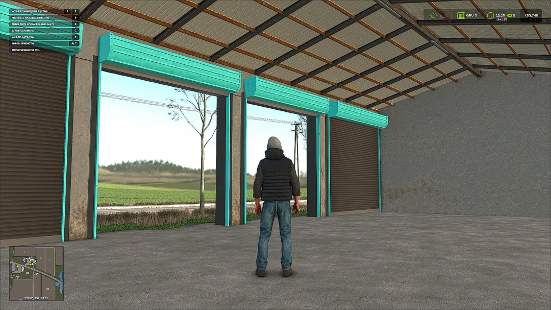 FS25 Garage With Shed mod featuring a character standing inside the garage with open doors and a scenic view in Farming Simulator 25.