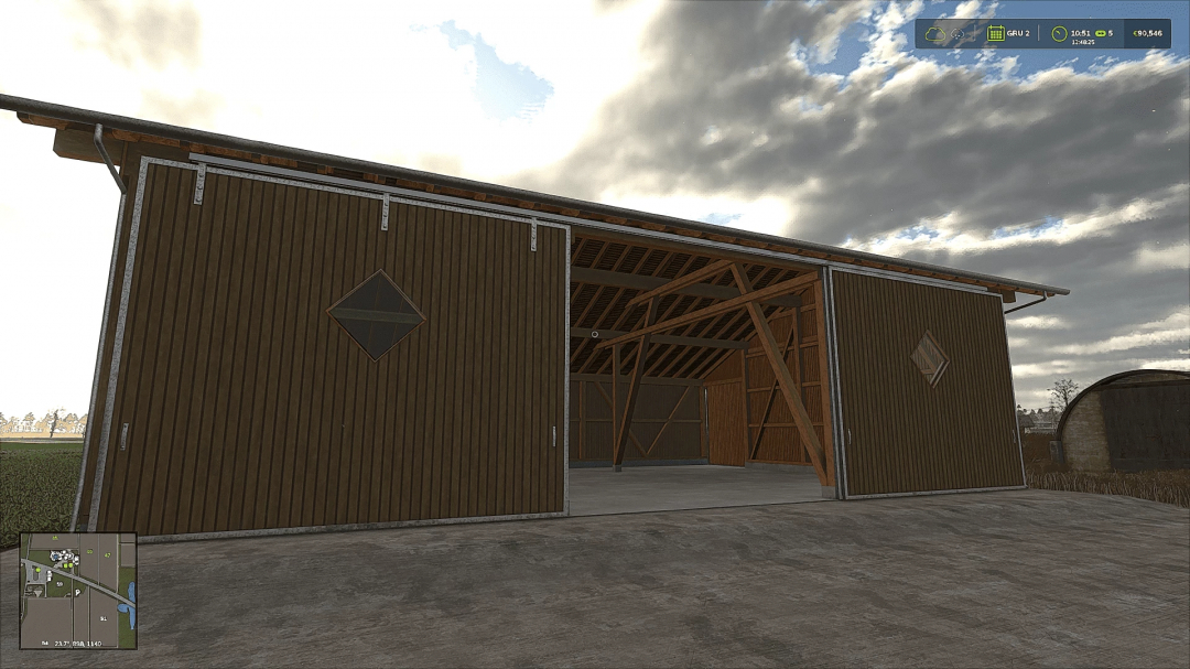 FS25 barnSet v1.0.0.0 mod shows a large wooden barn with open sliding doors under a cloudy sky in Farming Simulator 25.