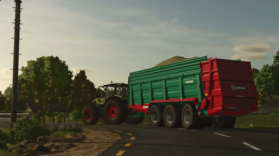 Farmtech Fortis 3000 mod in FS25, featuring a green and red trailer on a rural road with a tractor.