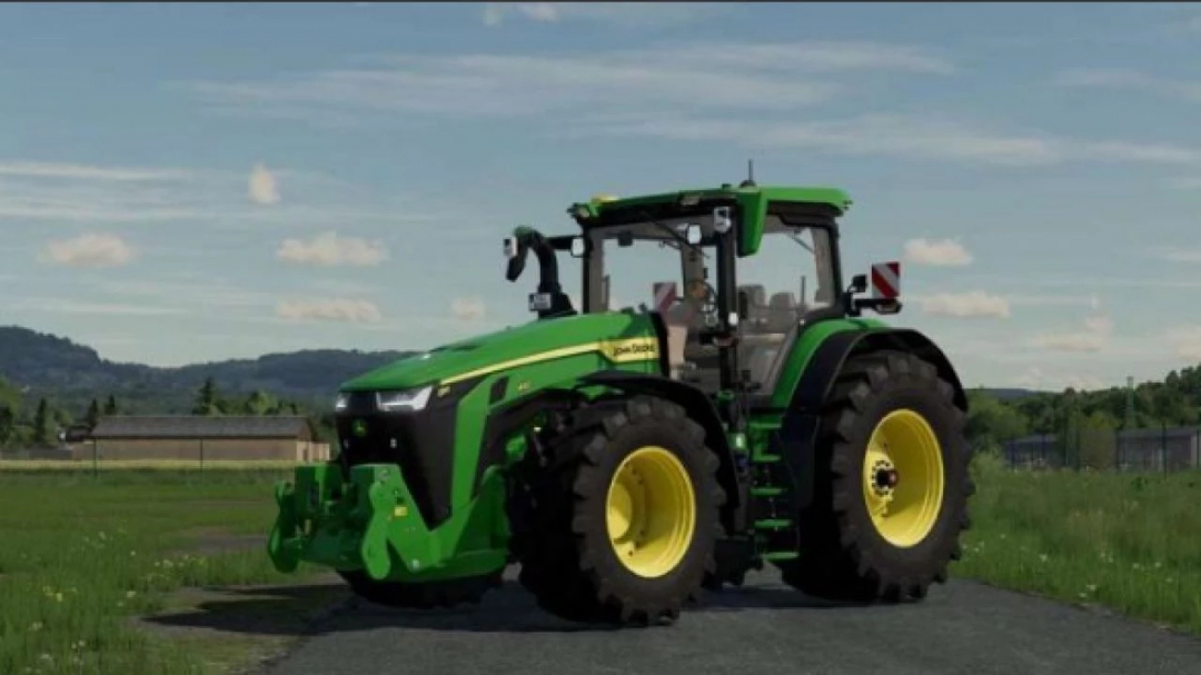 John Deere 8R US tractor mod for Farming Simulator 25, featuring green and yellow design on a rural road.