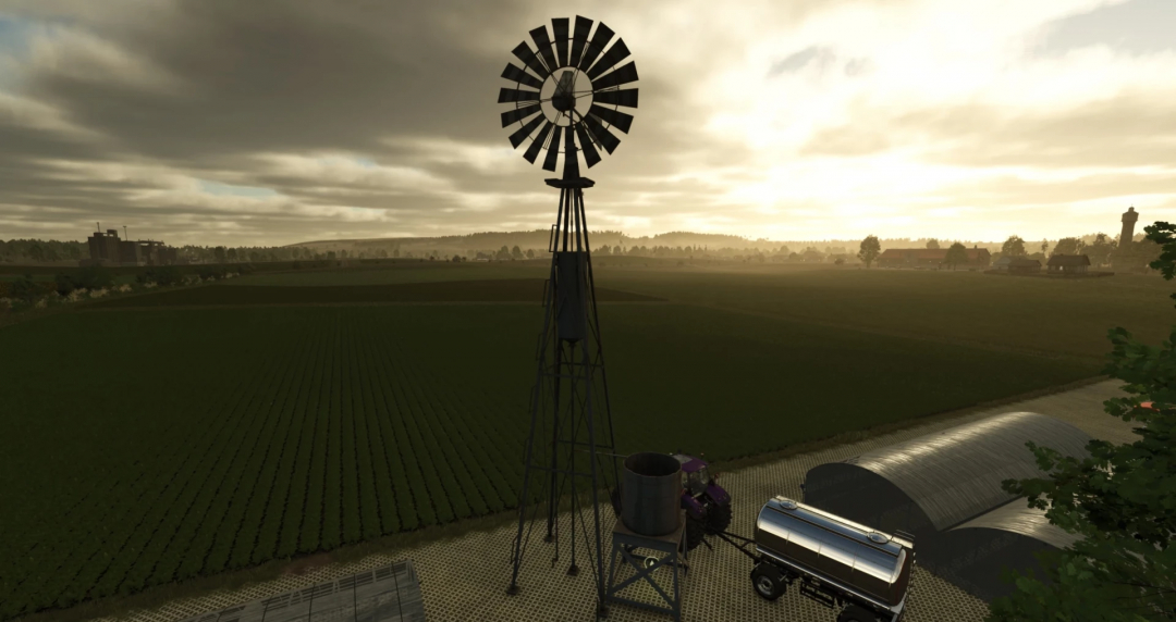 FS25-Mod zeigt ein altes Windrad mit Wassertank bei Sonnenaufgang.