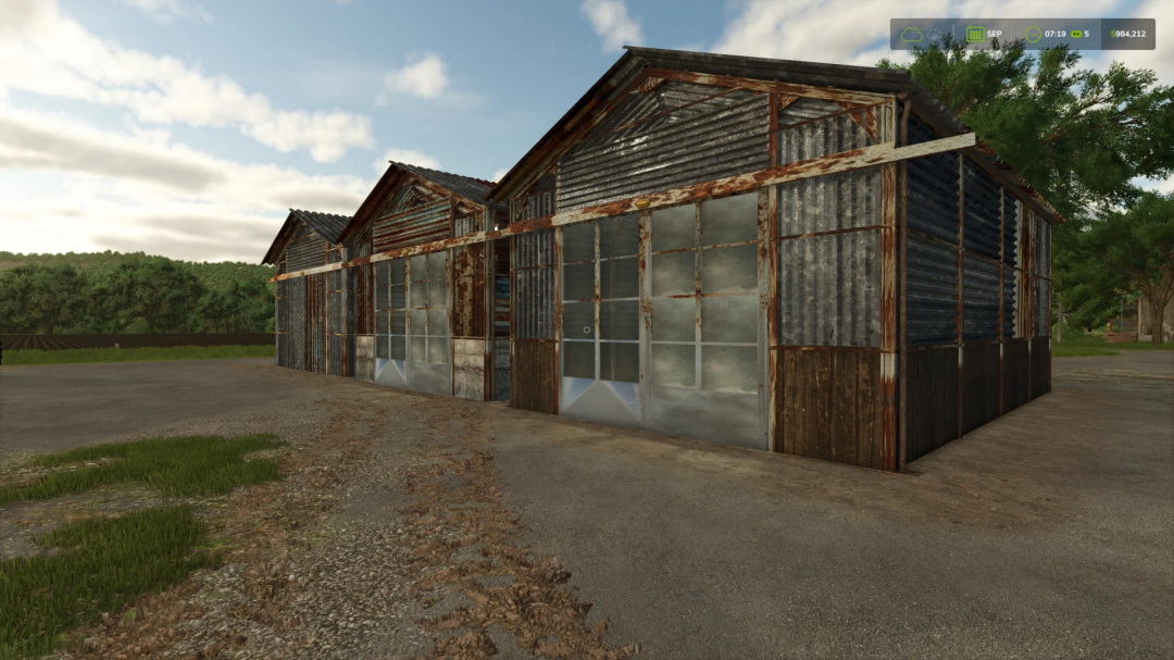 Rusty sheds mod in Farming Simulator 25, featuring weathered metal structures set against a rural landscape.