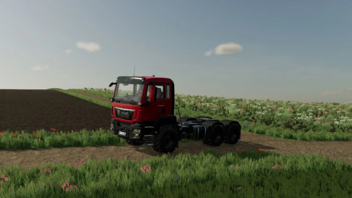 fs25-mods,  Red MAN TGS 6x6 truck mod in FS25 on a dirt road with fields and flowers.