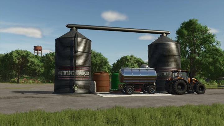 fs25-mods,  FS25 Multifruit and Liquid Silo mod showing silos, a tractor, and a trailer. Ideal for Farming Simulator 25 gameplay.