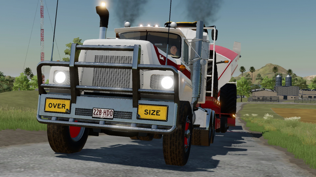 FS25 mod image showing Australian Mack R700/Superliner truck with oversize load on a rural road.