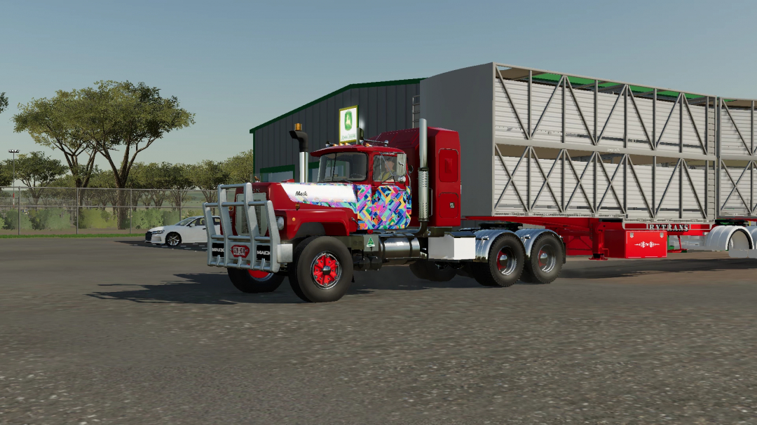 FS25 mod showing Mack R700 truck with vibrant paint and trailer.