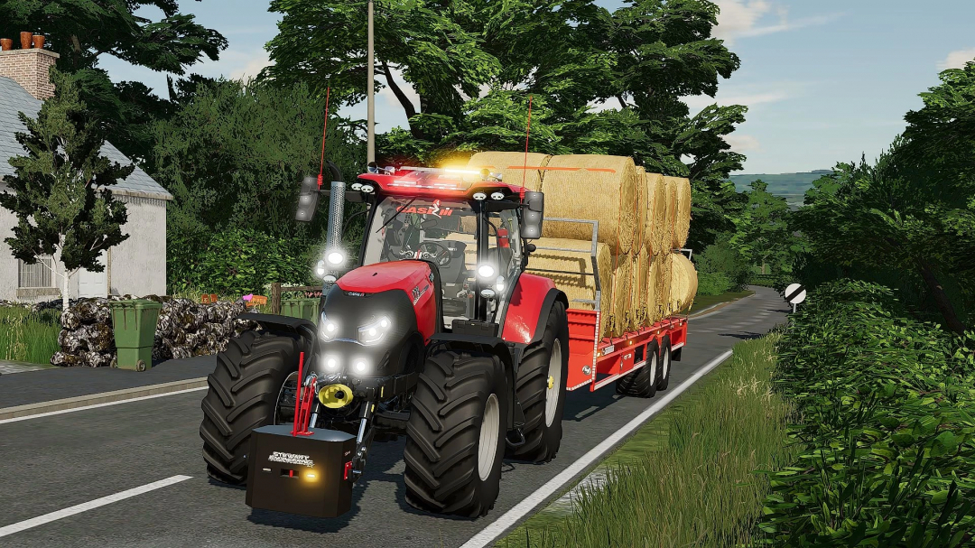 Case IH Puma 140-175cvx tractor mod in FS22 transporting hay bales on a country road.