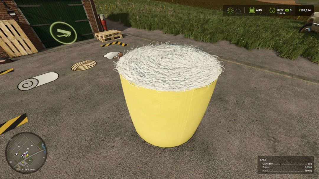 FS25 Cotton Production Pack mod showing a large yellow bale of cotton on a farm in Farming Simulator 25.