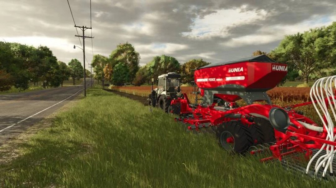 FS25 mod Fendt Vario 200 Edited V1.0.0.1 tractor with red Unia seed drill on a grassy road beside a field.