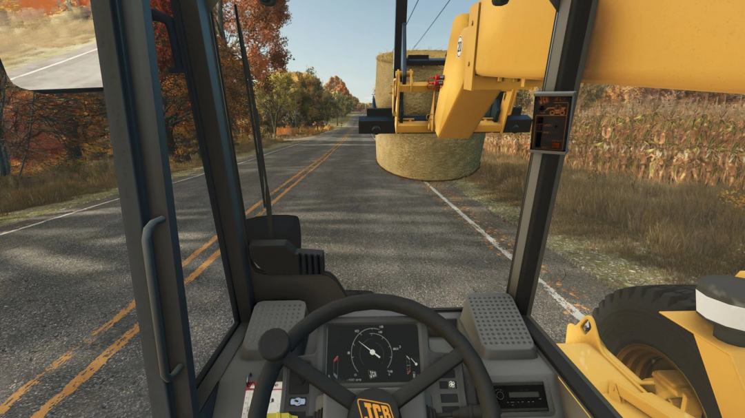 Interior view of JCB 525-67 in FS25 mod, showing steering wheel and control panel, with hay bale lifted on rural road.