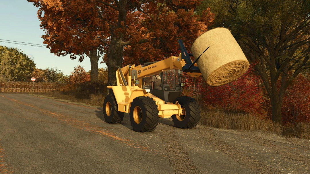 JCB 525-67 mod in FS25 lifting hay bale on rural road.