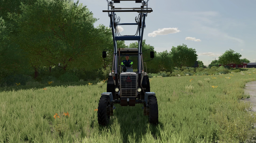 MTZ-100 tractor mod in FS22, showing front view in a grassy landscape.