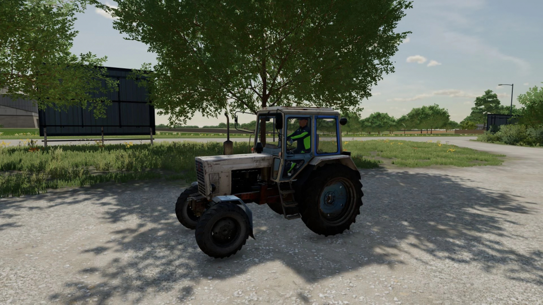 MTZ-100 tractor mod in FS22, parked near trees under sunlight