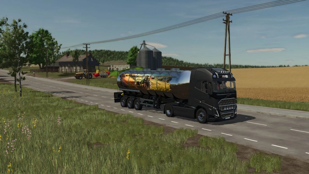 FS25 mod MultiTank MKS 32 on a black truck driving on a rural road, showcasing farming equipment.