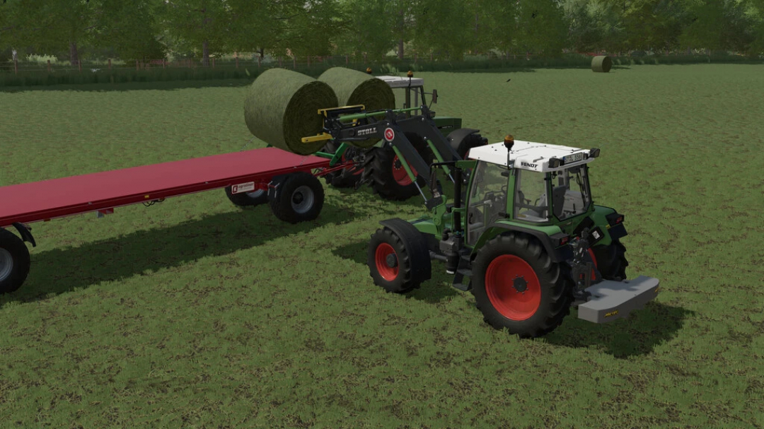 FS22 mods: Stoll Frontloader GTA Xylon Pack loading hay bales onto a trailer in Farming Simulator 22.