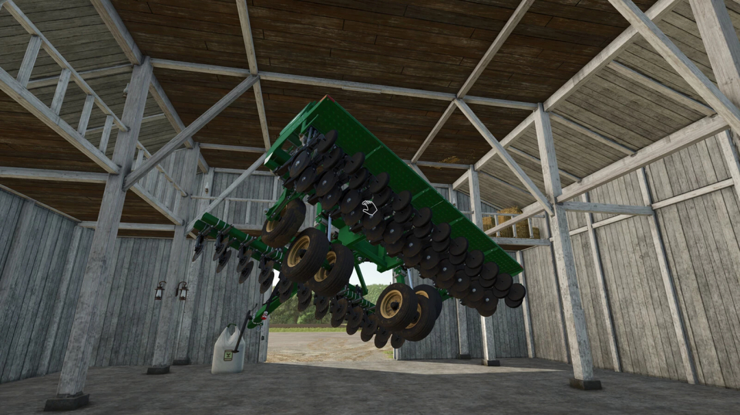 FS25 mod Super Strength v1.0.0.0 displays a green farming implement suspended upside down inside a wooden barn.