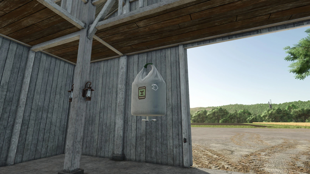 FS25 Super Strength mod shows a large fertilizer bag suspended in a barn, highlighting enhanced lifting abilities.