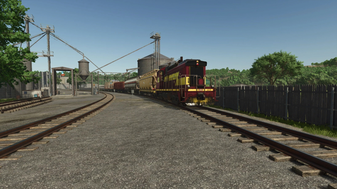 Train Stop mod in FS25 showing a freight train at a rural station