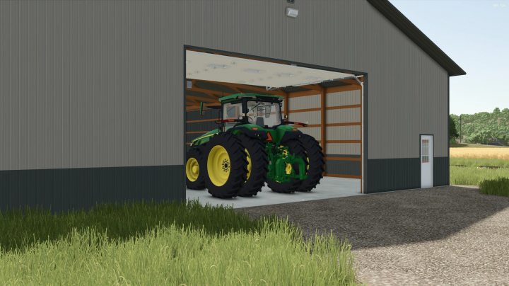 fs25-mods,  A large tractor inside an open FS25 60x88 Shed mod in Farming Simulator 25.