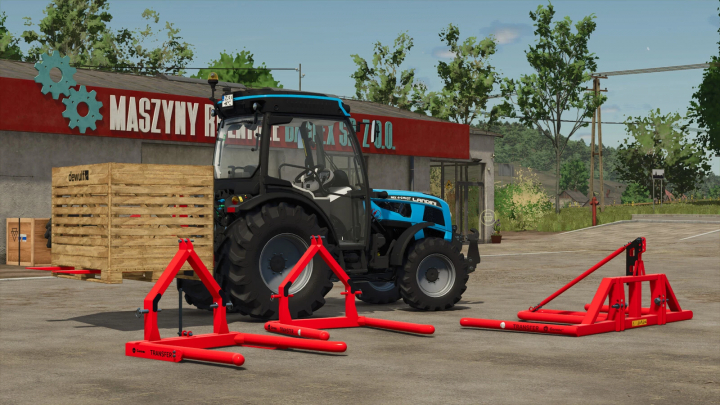 fs25-mods,  FS25 Gorenc Transfer Pack v1.0.0.0 mod showcasing a blue tractor and red equipment in front of a building.