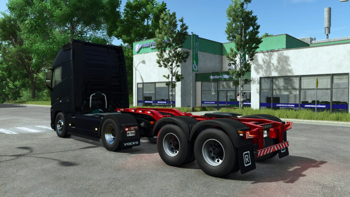 fs25-mods, FS25 mod Randon Dolly v1.0.0.0 showcasing a black truck with a red dolly parked in front of a service center.