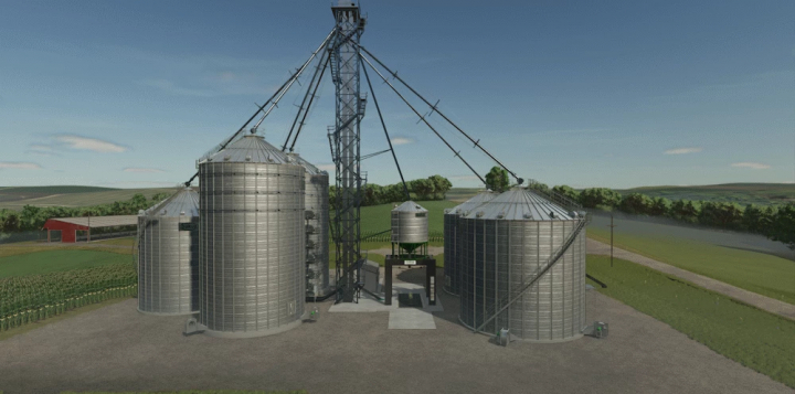 fs25-mods,  Sukup Bin Silo mod in Farming Simulator 25, showcasing metal silos in a rural landscape. FS25 mods enhance gameplay realism.