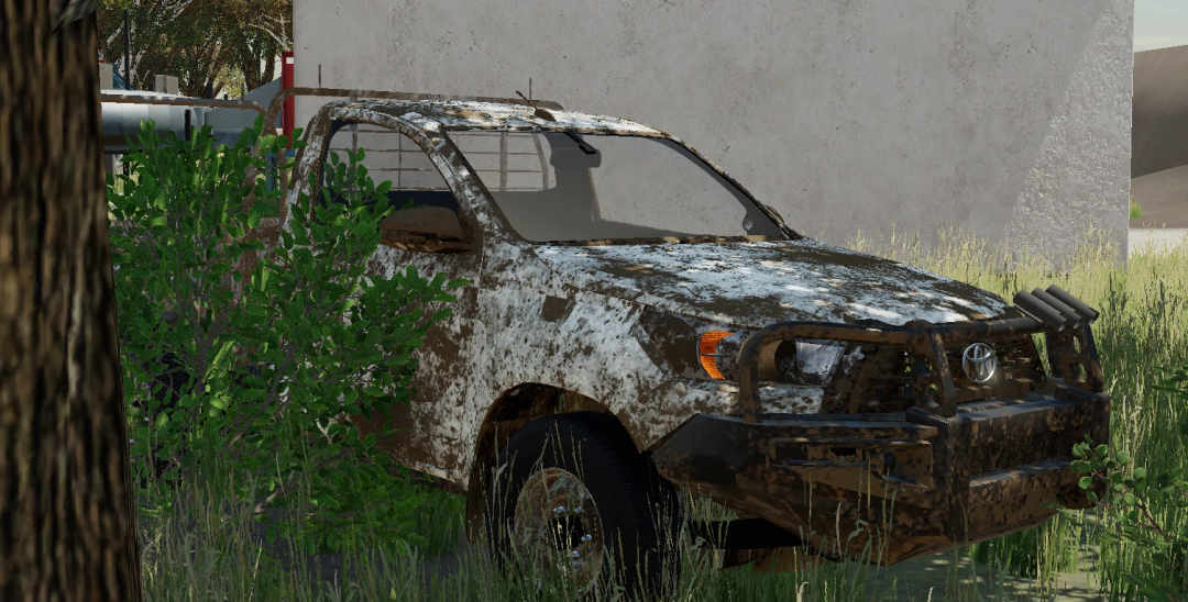 FS22 mod 2021 Toyota Hilux Ute, weathered and parked in overgrown grass.