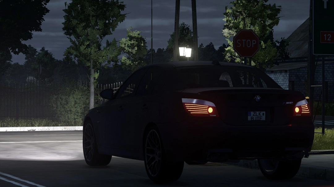 BMW E60 mod for Farming Simulator 25, showing a car at night near a stop sign.