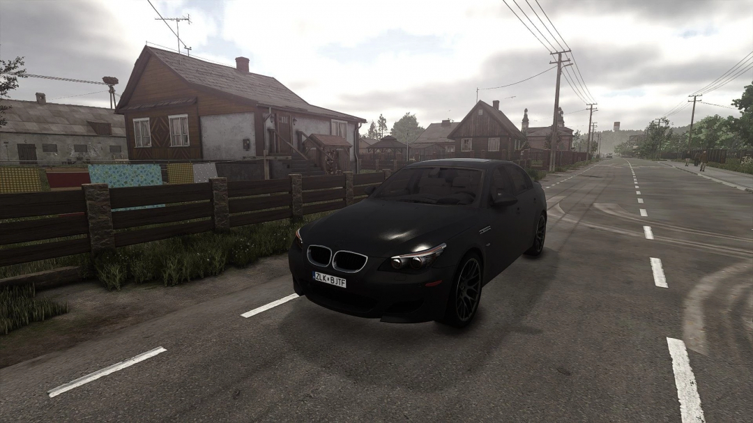 BMW E60 mod for FS25 parked on a rural road, showcasing detailed scenery.