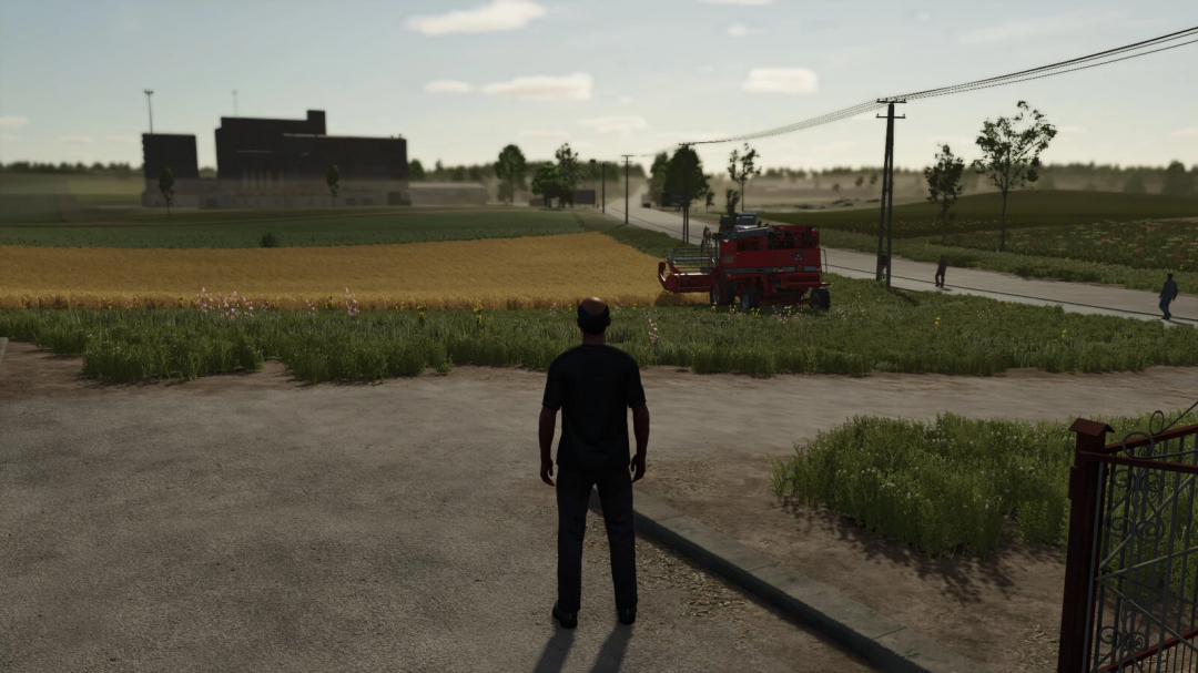 FS25 mod Disable Player Camera Blur shows a farmer observing a red harvester in a field.