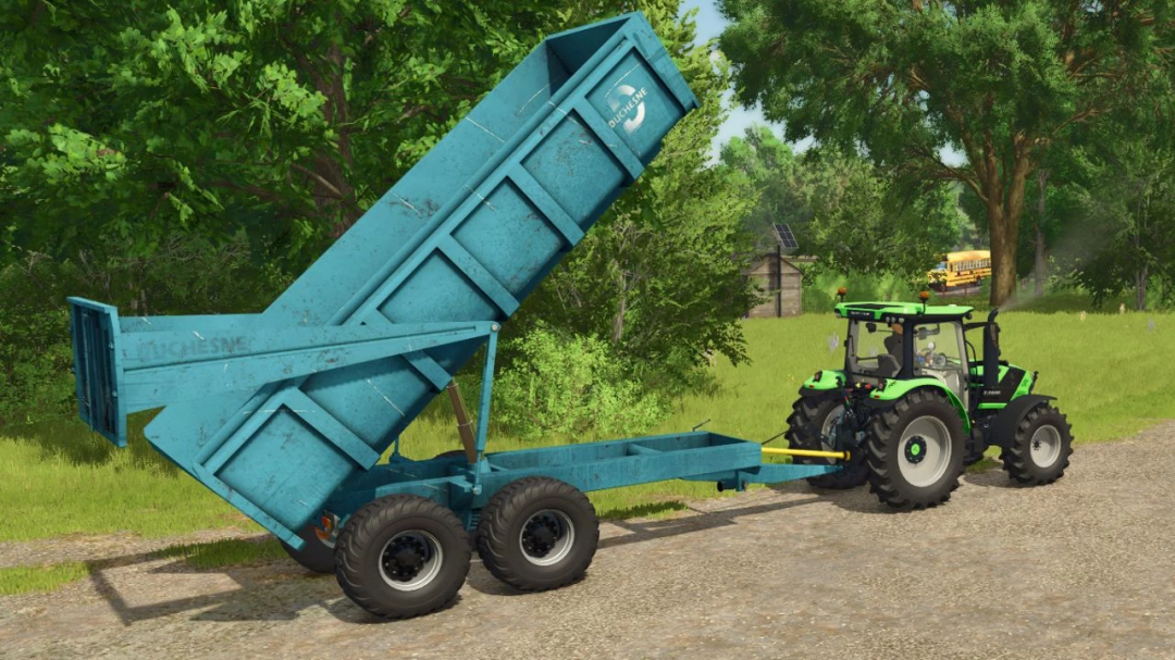 FS25 mod Duchesne 14T v1.0.0.0 showing blue trailer hitched to tractor on farm road.