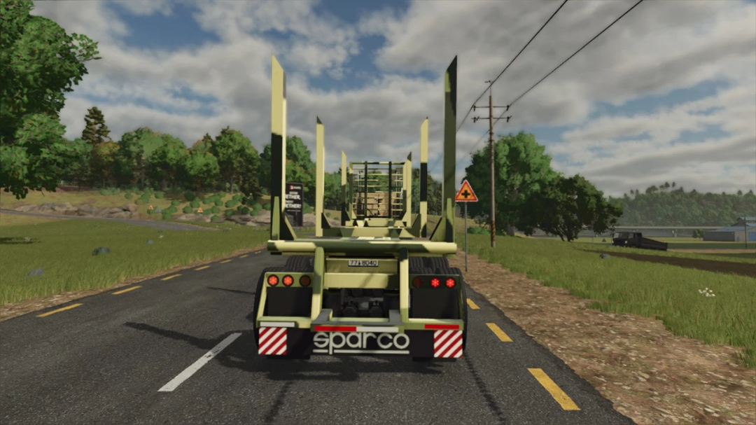 FT40 Trailer mod in Farming Simulator 25, driving on a rural road with green trees and cloudy sky.