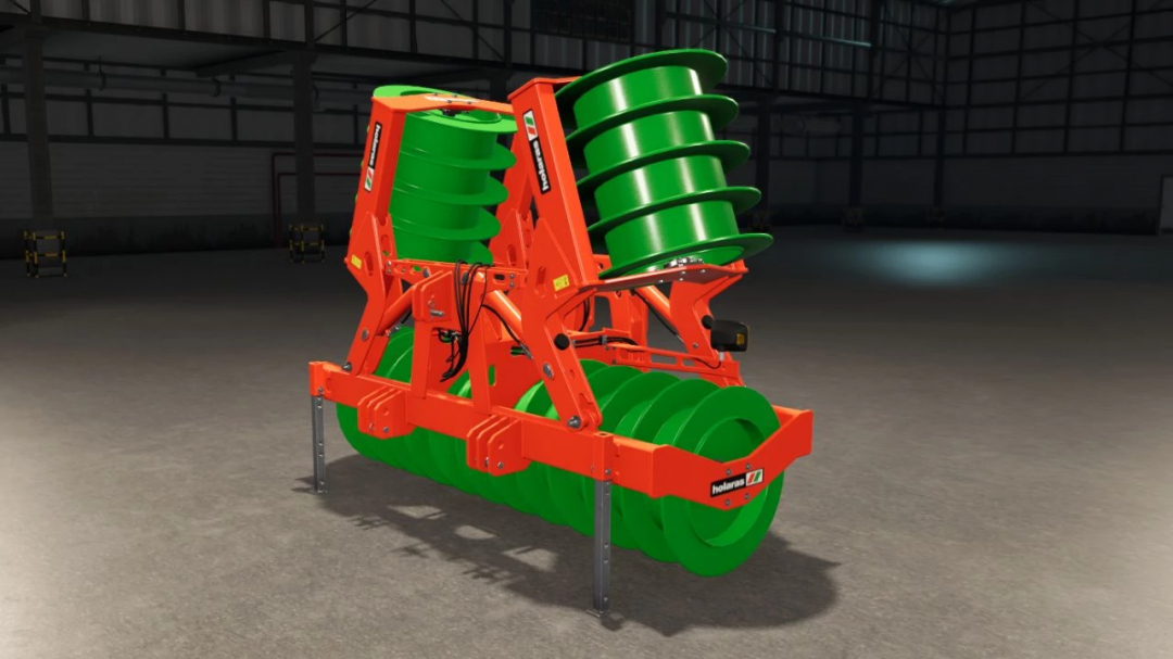 Holaras Stego 485 Pro Edit v1.0.0.0 mod for FS25, showcasing a vibrant green and orange agricultural machine in a warehouse setting.