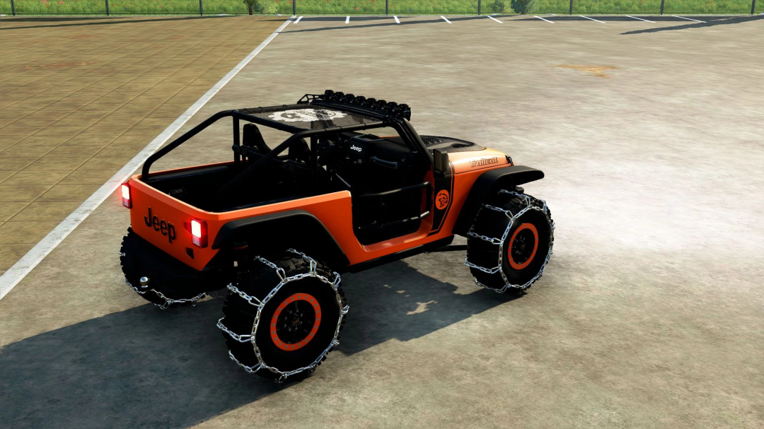 FS22 mod Jeep Trailcat v1.0.0.0 with orange body and tire chains in Farming Simulator 22.