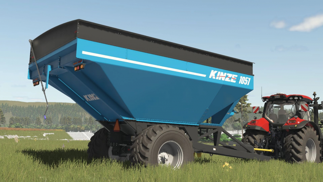 FS25 mod Kinze Wagon Pack v1.0.0.0 showing a blue grain cart attached to a red tractor in a field.