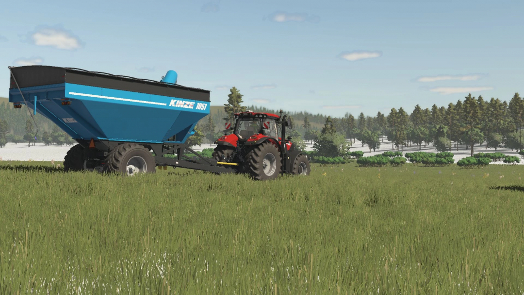 FS25 Kinze Wagon Pack mod showing a blue trailer attached to a red tractor in a green field.