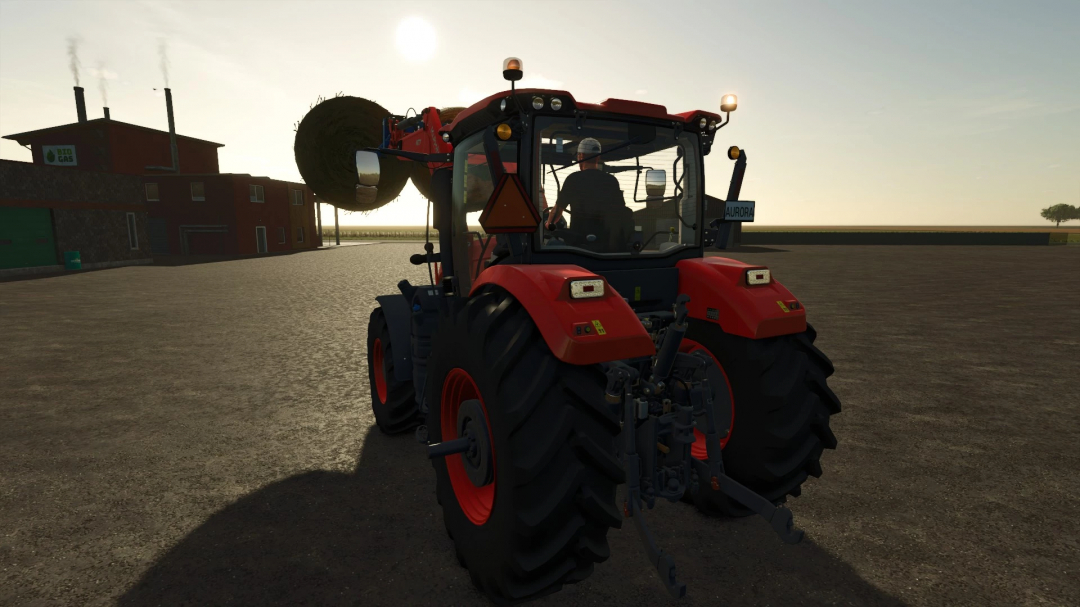 Kubota M8-Series tractor in Farming Simulator 25 mod, carrying hay bale. FS25 mods enhance gameplay realism.