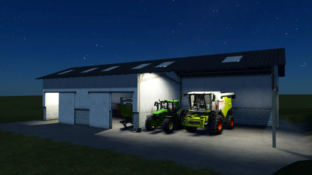 Open Building mod in FS25 features a lit barn at night with tractors and equipment inside.