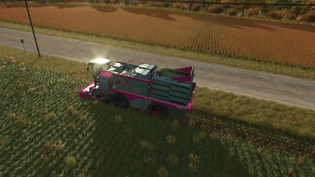 FS25 Oxbo Pack v1.0.0.0 mod featuring a pink and green harvester in a field next to a road.