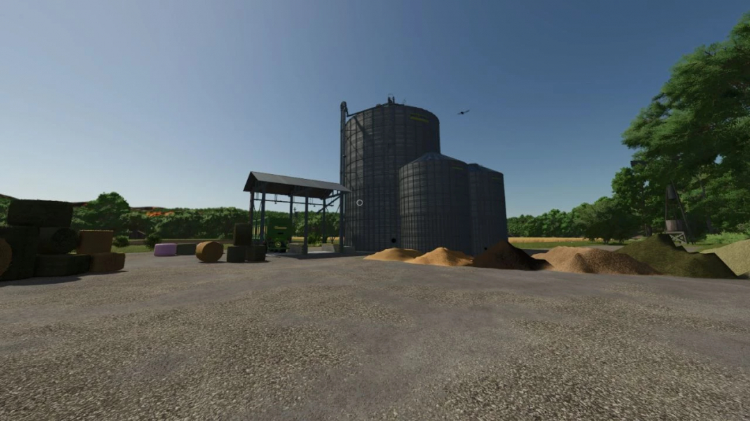 FS25 Real Feed Pack v2.0.0.2 mod showing feed silos and hay bales in a farmyard.