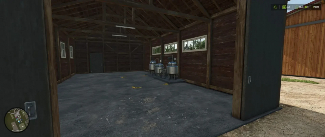 Interior of Small Dairy Building mod in FS25, showing equipment and wooden walls.