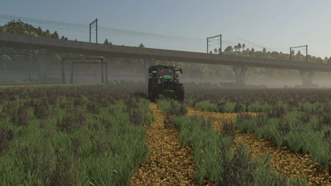 FS25 mod Stubble destruction v1.0.0.2 shows a tractor in a misty field beneath a bridge.