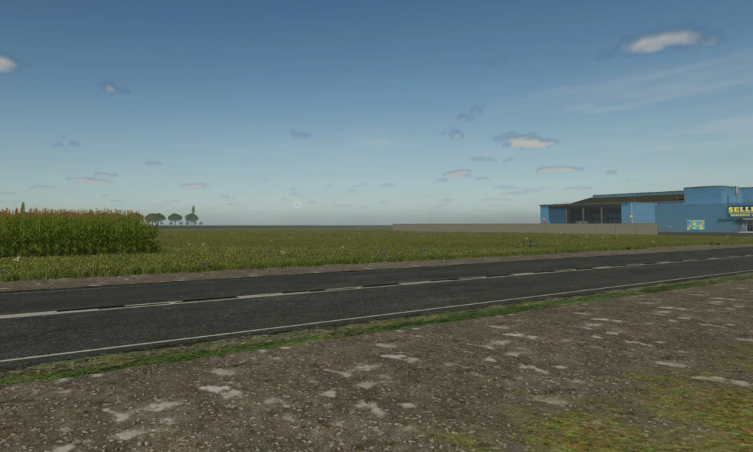 FS25 US Flatlands Map 4x v1.3.0 featuring a road, fields, and industrial buildings under a clear blue sky.