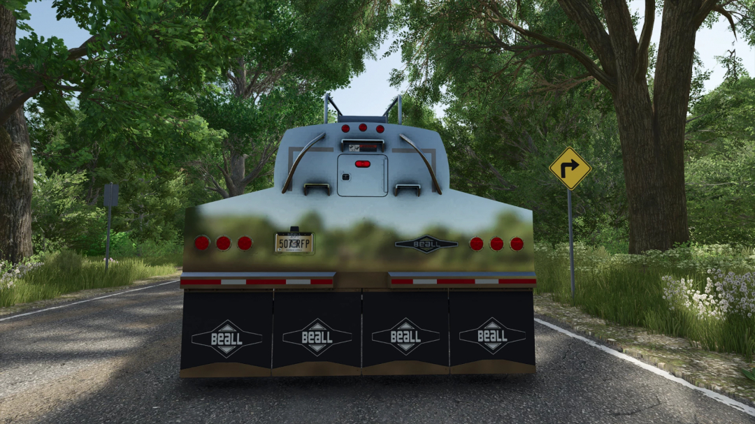 Back view of Beall Bullet Quad Axle Belly Dump mod for FS25, surrounded by trees and a road sign.