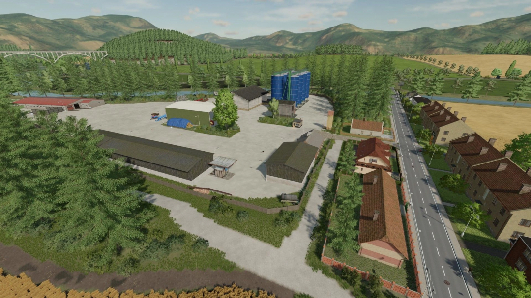 Bohemia Country mod for FS22 showcases farm complex with silos, buildings, and road surrounded by lush landscape.