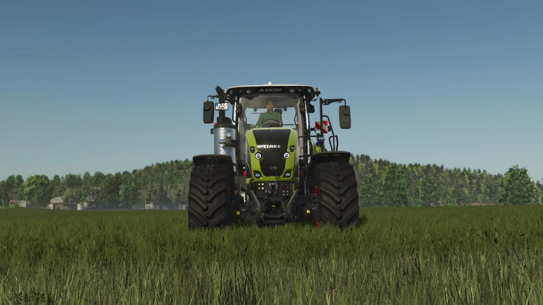 Front view of Claas Axion 960TT tractor mod in FS25, showcasing its design in a green field.