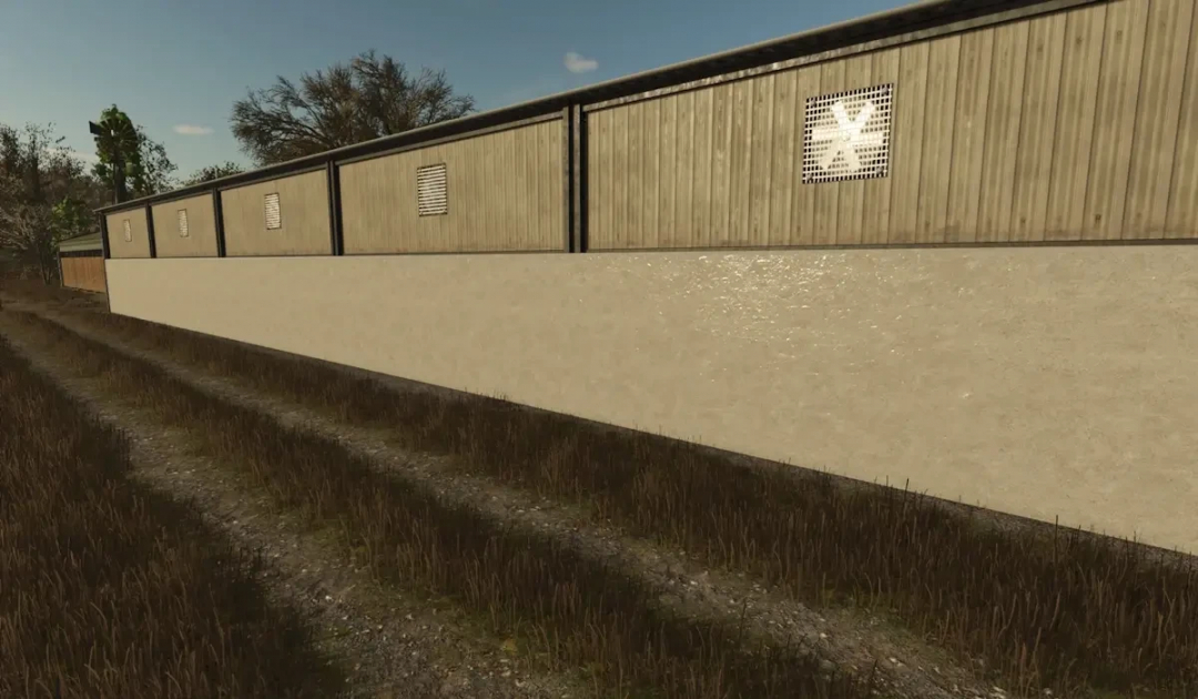 FS25 mod image showcasing FBM25 Bulk Hall v1.0.0.0, featuring a large warehouse with wooden siding and ventilation on a dirt path.