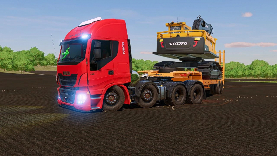 Iveco 440 truck mod in FS25, towing a Volvo construction vehicle on a field.