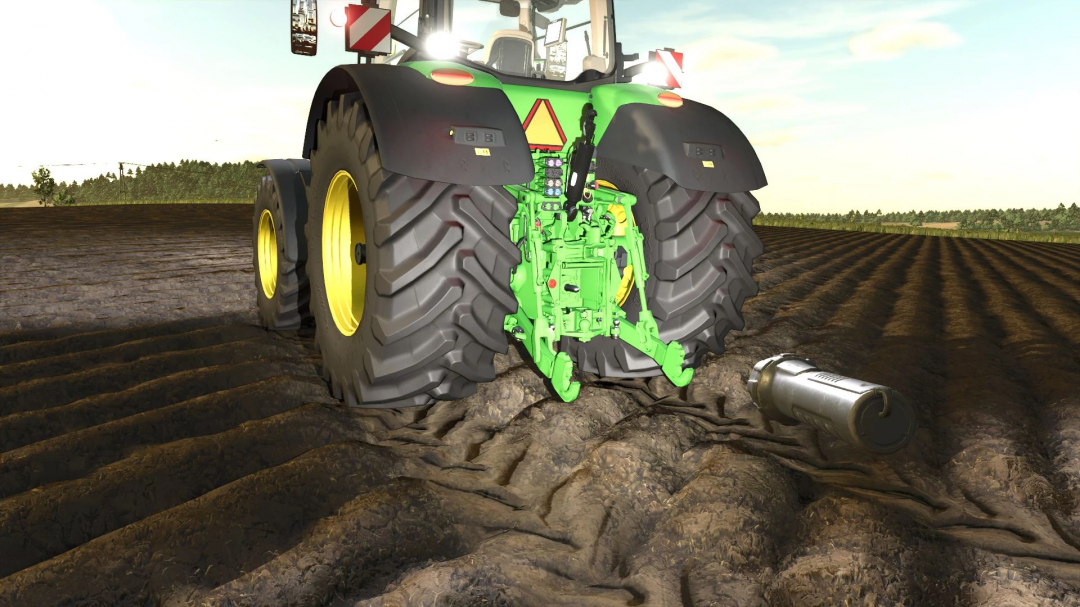 Rear view of John Deere 8R 2016 mod in FS25, showcasing its details on a plowed field.