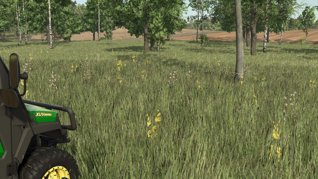 Close-up of John Deere XUV 865M mod in FS25, showcasing vibrant grassy field and trees.